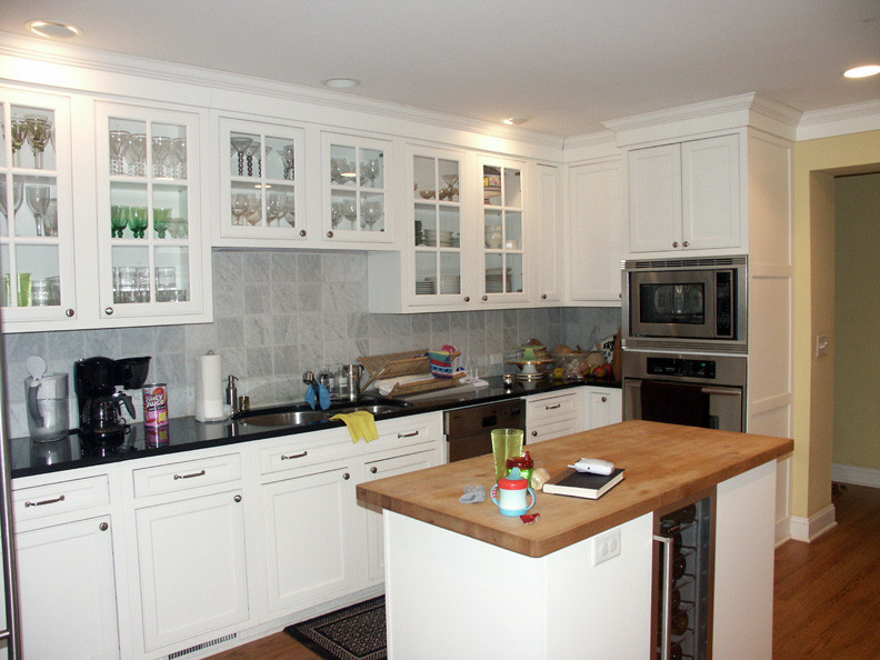 Glass Cabinet Doors frame the Kitchen sink, storage, oven and work areas