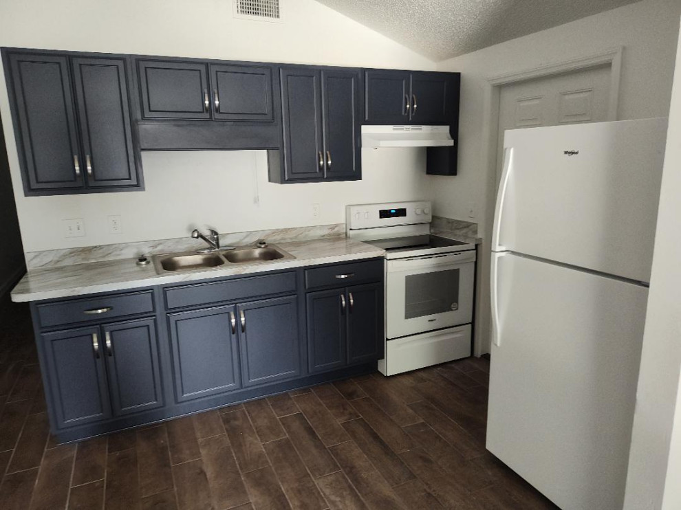 Inspiration for a small single-wall eat-in kitchen remodel with a double-bowl sink, flat-panel cabinets, blue cabinets, laminate countertops, white appliances and no island