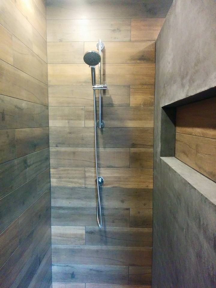 Photo of a mid-sized modern bathroom in Montreal with a drop-in sink, open cabinets, grey cabinets, concrete benchtops, an open shower, a one-piece toilet, gray tile, cement tile, grey walls and ceramic floors.