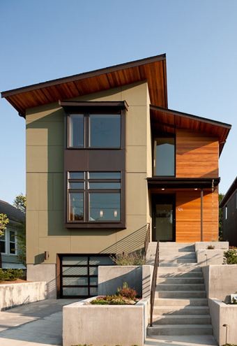 Photo of a mid-sized modern two-storey green house exterior in Seattle.