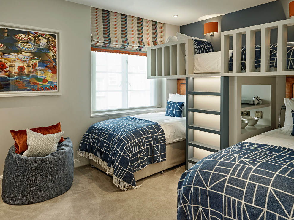 Photo of a mid-sized transitional kids' bedroom for boys in London with carpet and grey floor.