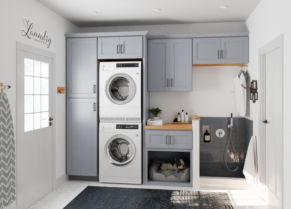 Traditional laundry room in Other with shaker cabinets, blue cabinets and a stacked washer and dryer.