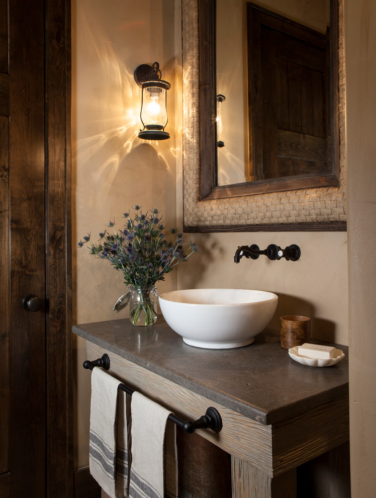 Country powder room in Austin with beige walls and a vessel sink.
