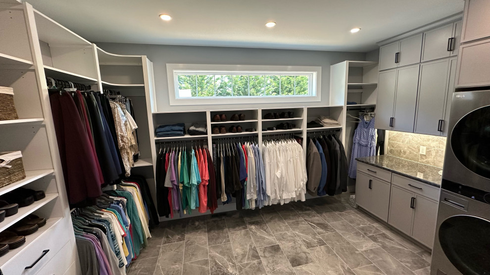 Design ideas for a large transitional gender-neutral walk-in wardrobe in Philadelphia with open cabinets, white cabinets, laminate floors and grey floor.