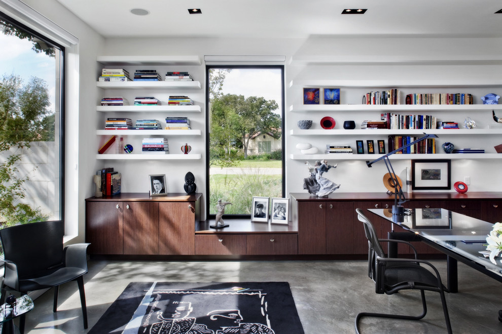 Contemporary home office in Other with concrete floors.