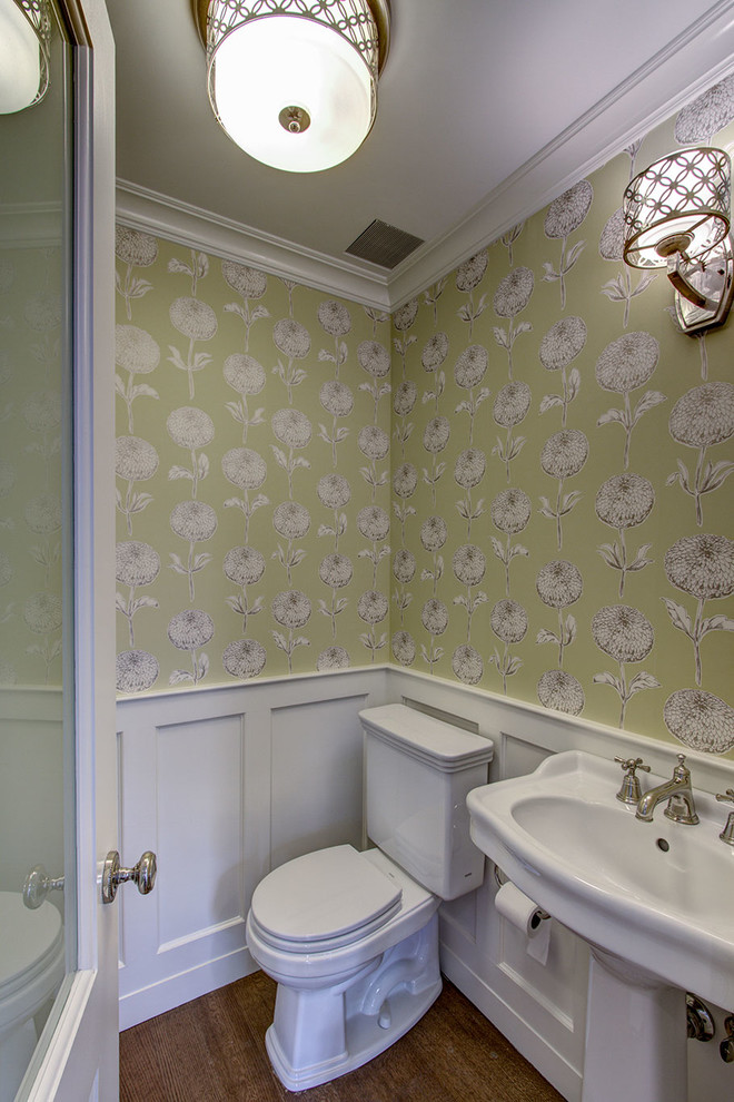This is an example of a traditional powder room in New York with a pedestal sink and a two-piece toilet.