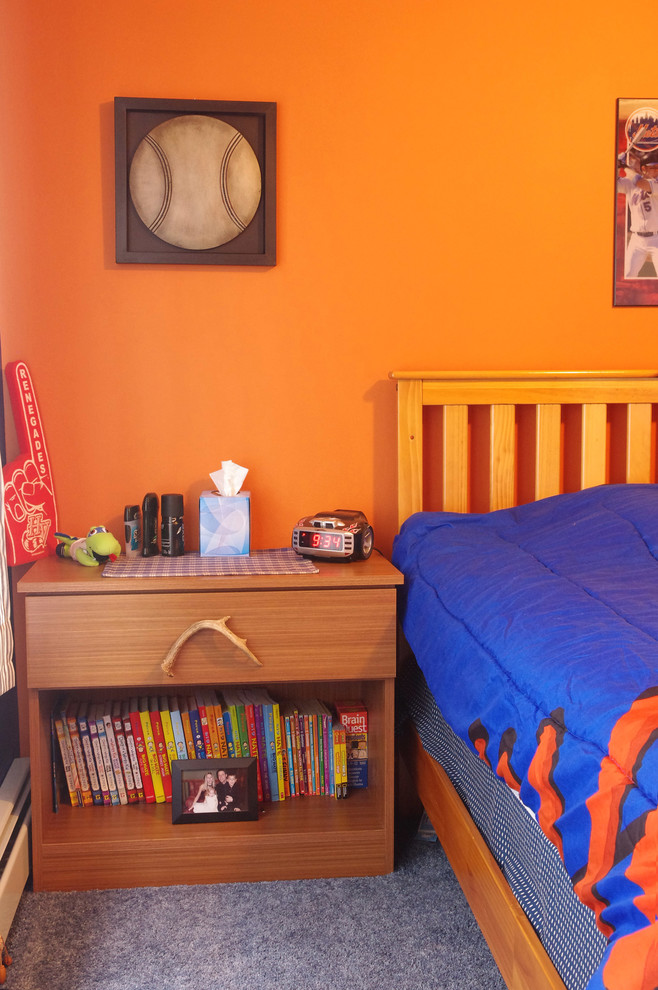 Mid-sized eclectic bedroom in New York with orange walls and carpet.