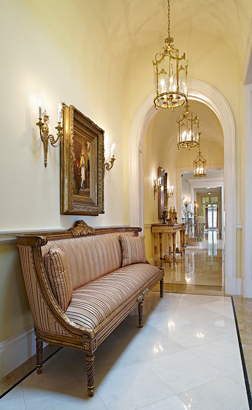 Photo of a mid-sized traditional hallway in Santa Barbara with green walls, marble floors and white floor.