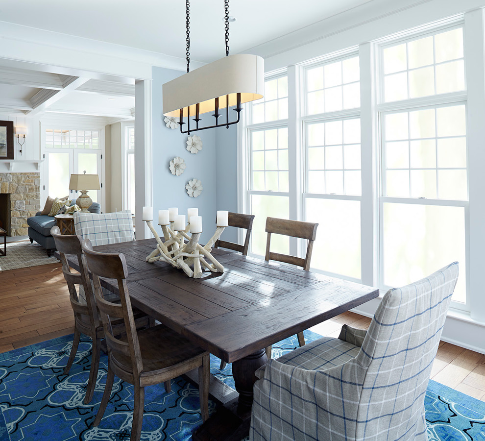 This is an example of a beach style dining room in Minneapolis with blue walls and no fireplace.