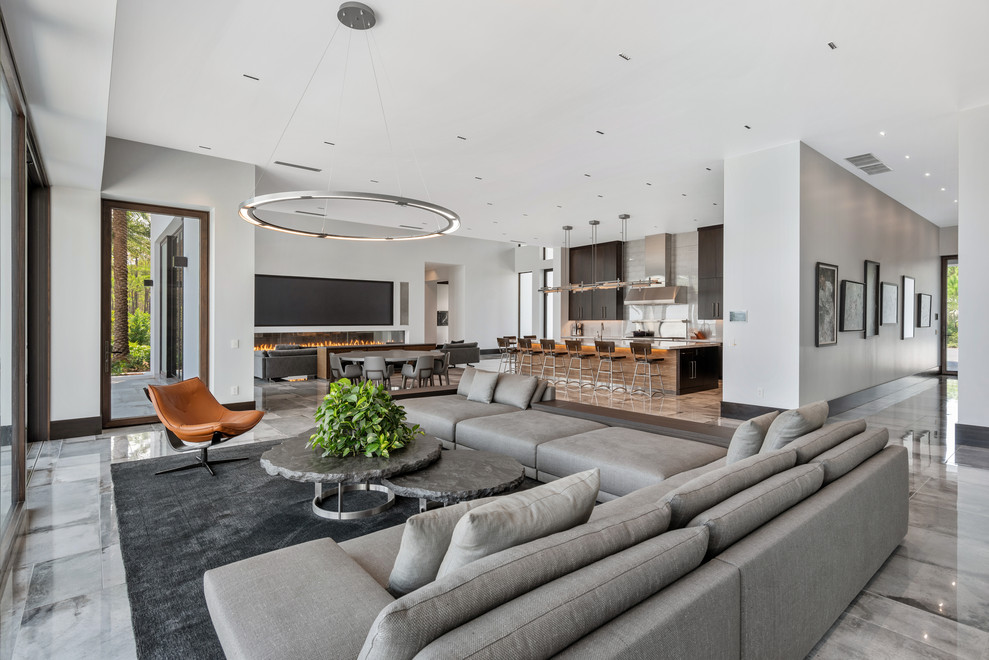 Contemporary open concept living room in Other with white walls and grey floor.