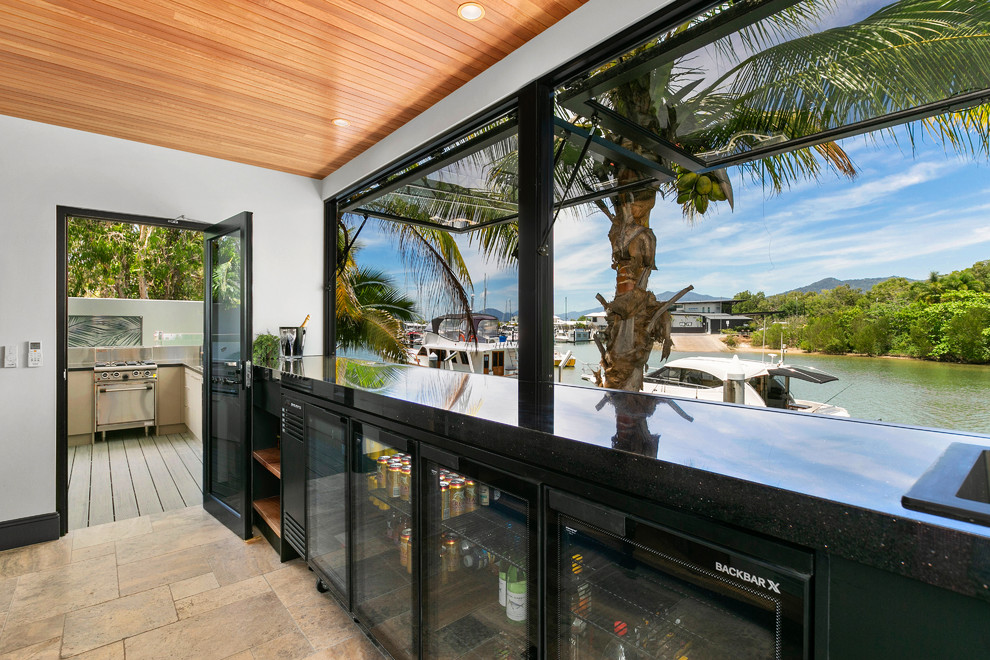 Tropical home bar in Cairns with open cabinets, black cabinets, granite benchtops and black benchtop.