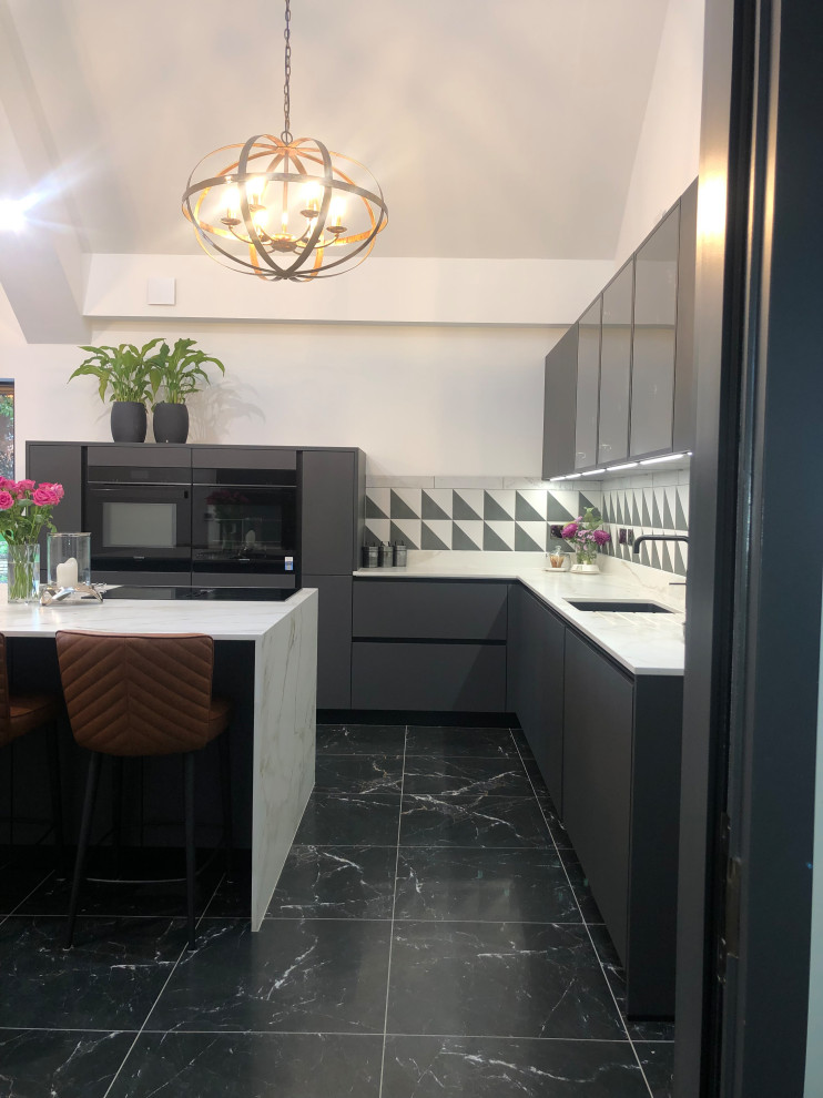 Inspiration for a large contemporary l-shaped eat-in kitchen in Other with an undermount sink, flat-panel cabinets, black cabinets, quartzite benchtops, multi-coloured splashback, porcelain splashback, porcelain floors, with island, black floor, white benchtop, vaulted and panelled appliances.