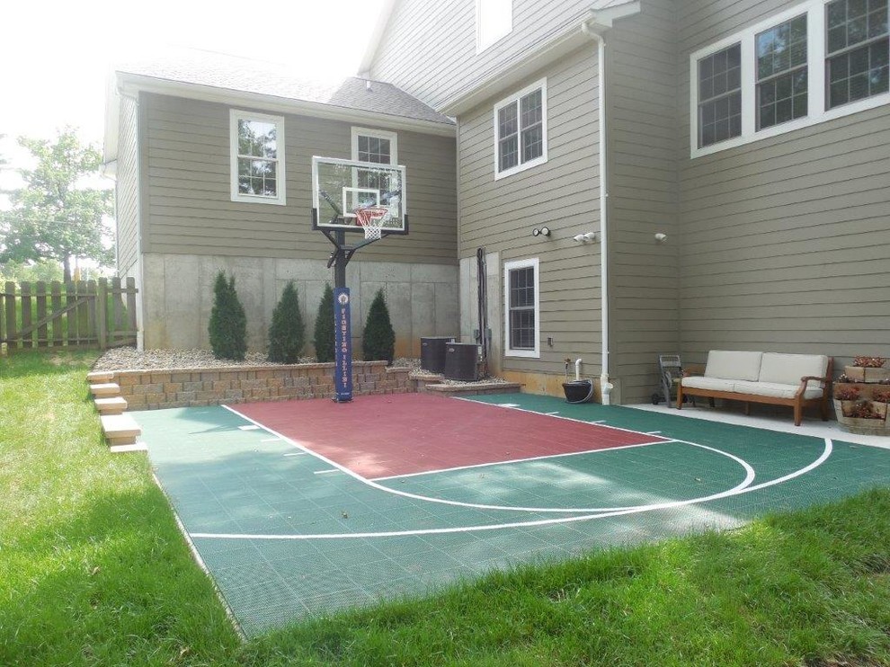 Large traditional side yard partial sun outdoor sport court in St Louis with a retaining wall for summer.