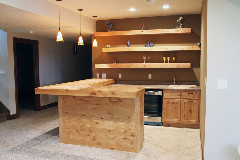 Small country l-shaped seated home bar in St Louis with a drop-in sink, shaker cabinets, light wood cabinets and wood benchtops.
