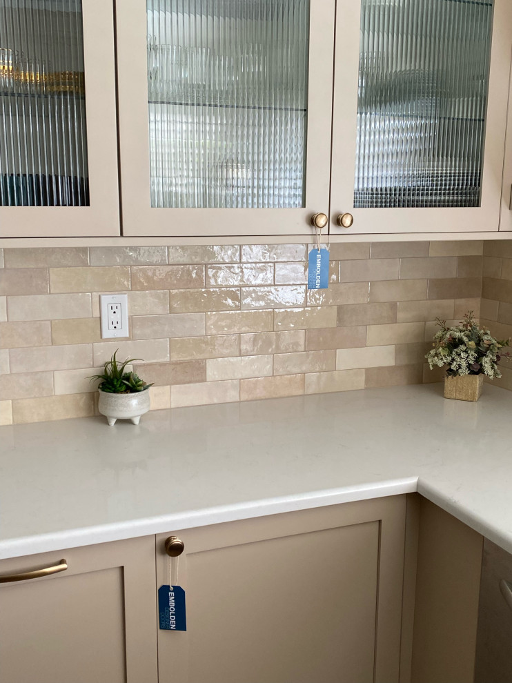 This is an example of a medium sized classic u-shaped enclosed kitchen in Los Angeles with a belfast sink, shaker cabinets, brown cabinets, brown splashback, ceramic splashback, stainless steel appliances, cement flooring, no island, beige floors and white worktops.