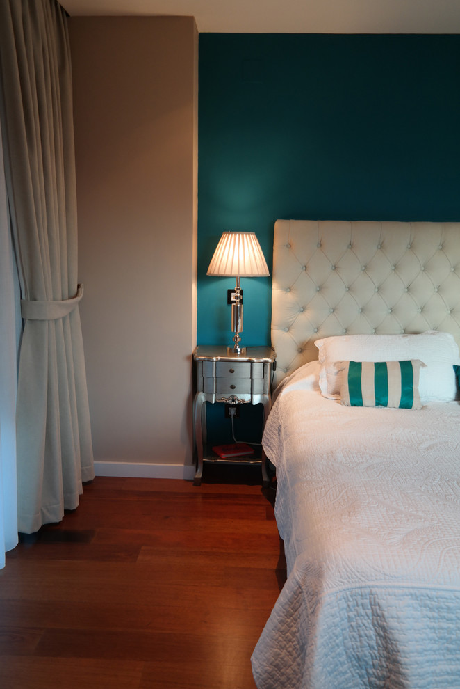 Diseño de dormitorio principal romántico grande con paredes azules, suelo de madera en tonos medios y suelo marrón