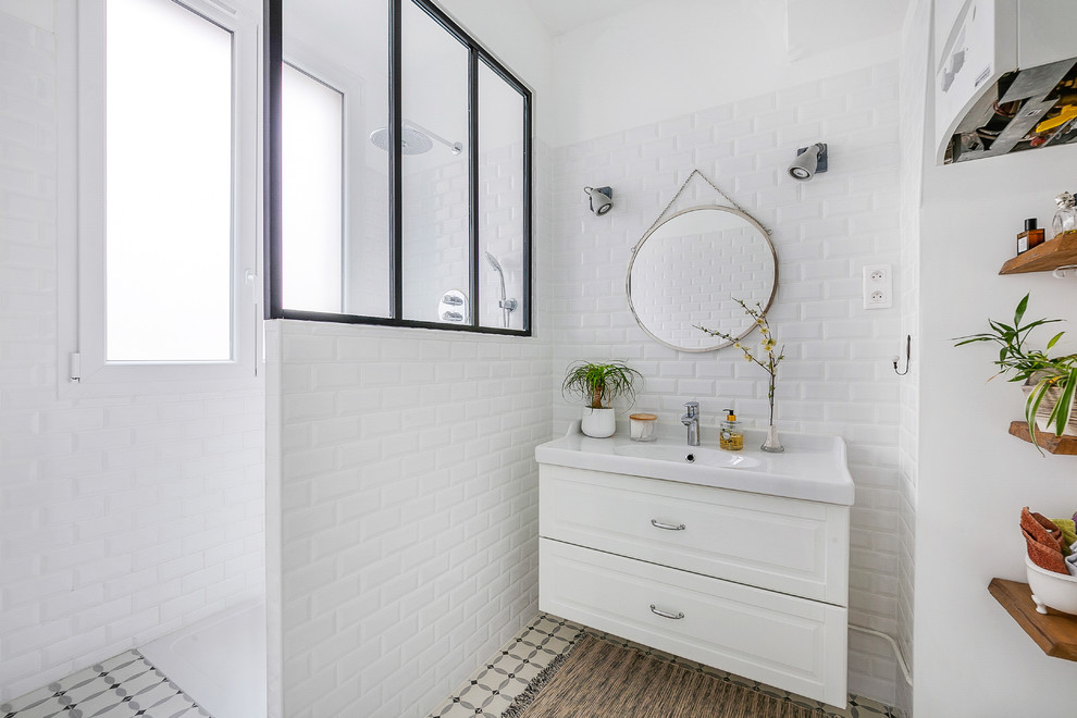 Photo of a mid-sized scandinavian master bathroom in Paris with an open shower, subway tile, white walls, cement tiles, a console sink and an open shower.