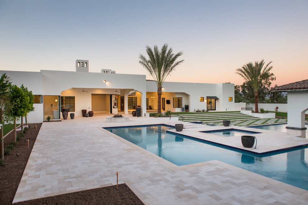 Large contemporary backyard l-shaped aboveground pool in Phoenix with a water feature and tile.