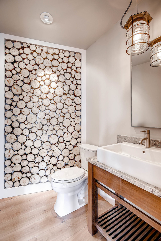 Mountain style light wood floor bathroom photo in Denver with a vessel sink, medium tone wood cabinets, gray walls and gray countertops