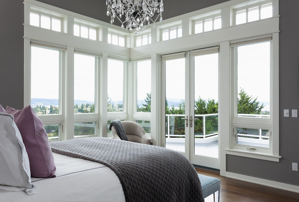 Inspiration for a mid-sized transitional master bedroom in Seattle with grey walls, medium hardwood floors, no fireplace and brown floor.