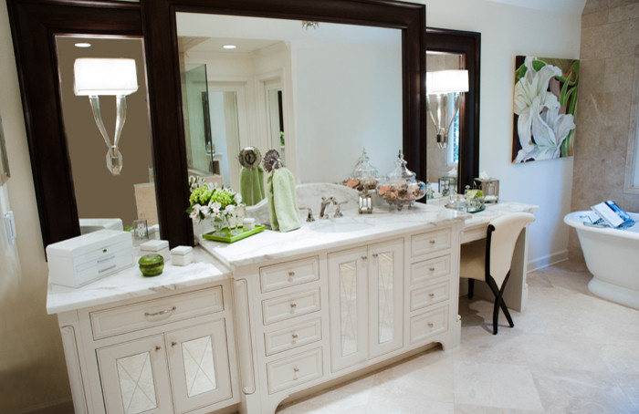 Inspiration for a large transitional master bathroom in Other with an undermount sink, recessed-panel cabinets, white cabinets, marble benchtops, a freestanding tub, a corner shower, a one-piece toilet, beige tile, stone tile, beige walls and limestone floors.