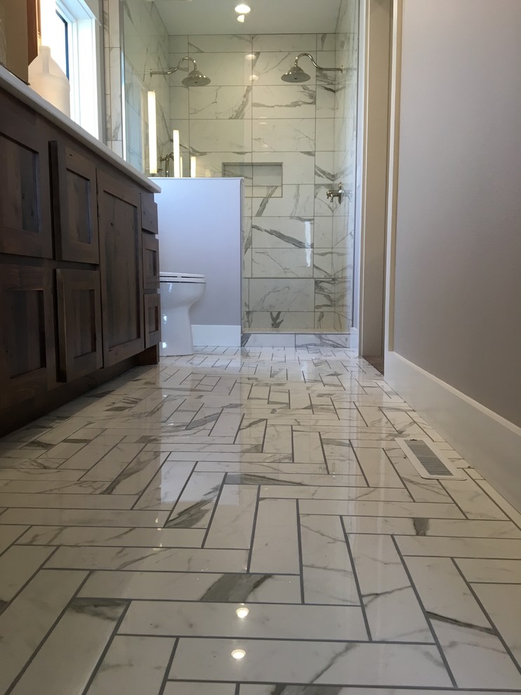 Design ideas for a mid-sized traditional 3/4 bathroom in Other with shaker cabinets, grey cabinets, an alcove shower, gray tile, white tile, porcelain tile, grey walls, pebble tile floors, a vessel sink and laminate benchtops.