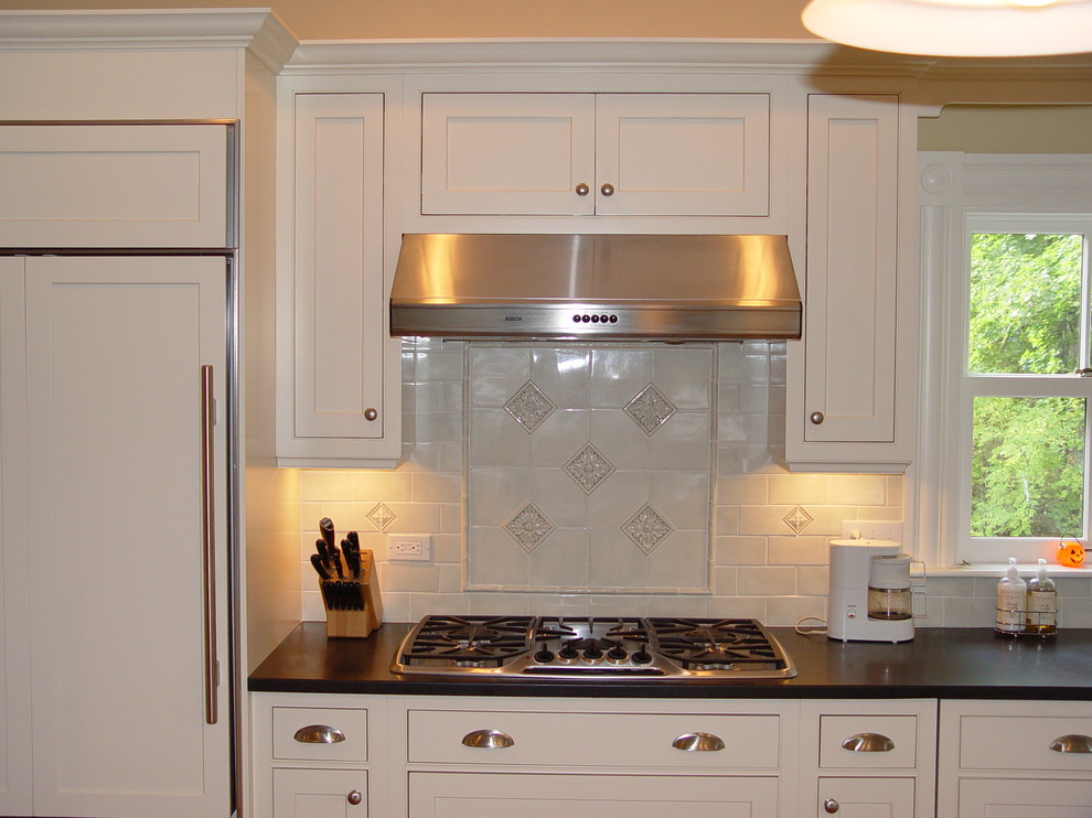 Inspiration for a transitional medium tone wood floor eat-in kitchen remodel in Boston with an undermount sink, beaded inset cabinets, white cabinets, granite countertops, white backsplash, subway tile backsplash, paneled appliances, yellow walls and an island