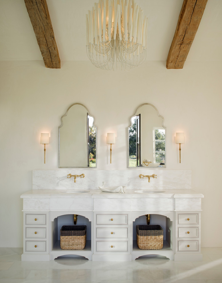 Design ideas for a mediterranean master bathroom in San Diego with beige cabinets, beige walls and an undermount sink.