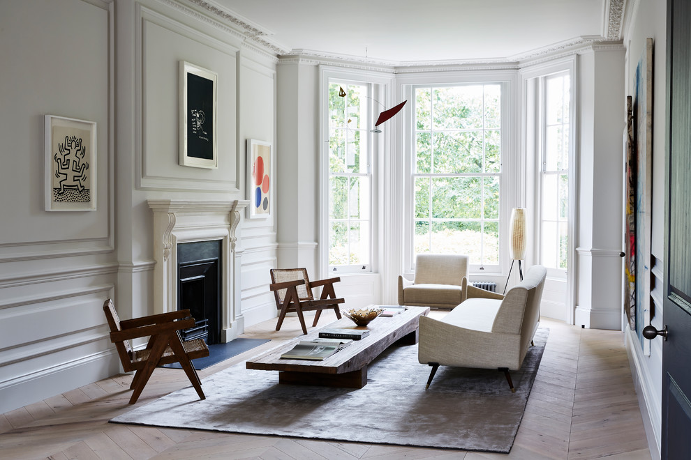 This is an example of a large contemporary formal living room in London with white walls, light hardwood floors, a standard fireplace and beige floor.