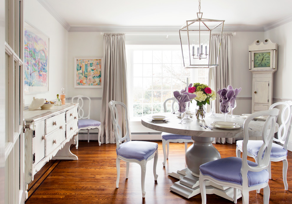 Photo of a mid-sized traditional separate dining room in Boston with white walls, dark hardwood floors and brown floor.