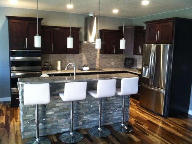 Inspiration for a large galley light wood floor enclosed kitchen remodel in Cedar Rapids with a drop-in sink, flat-panel cabinets, black cabinets, metallic backsplash and an island