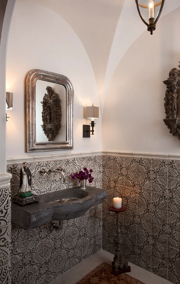 This is an example of a mediterranean powder room in Austin with terra-cotta tile.