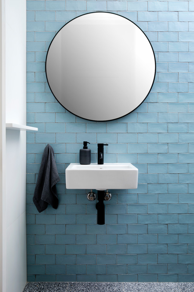 Design ideas for a beach style bathroom in Sydney with blue tile, subway tile, blue walls, a wall-mount sink and grey floor.
