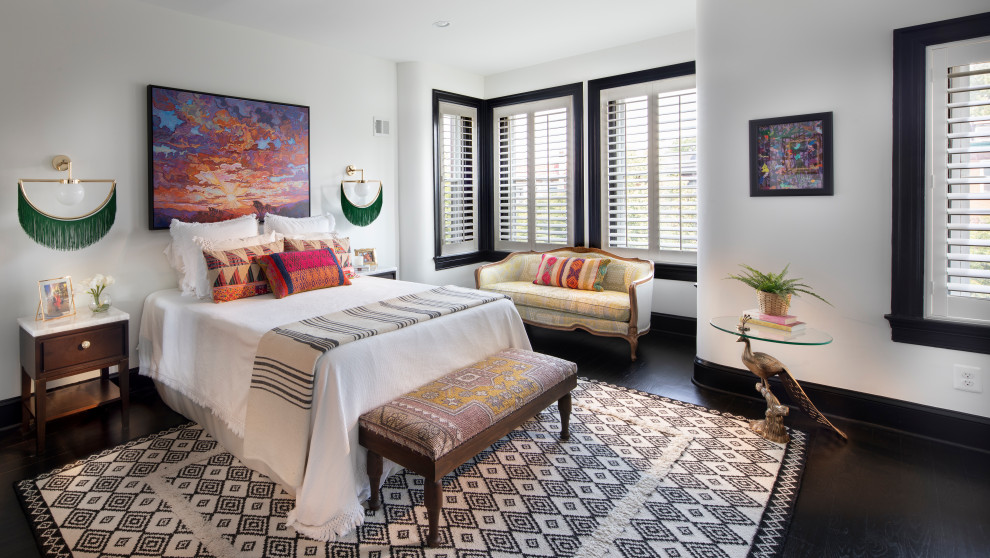 Example of a mid-sized eclectic master dark wood floor and black floor bedroom design in DC Metro with white walls