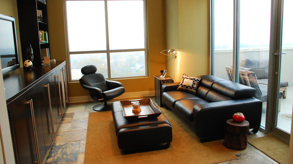 Example of a large trendy loft-style ceramic tile family room library design in Atlanta with beige walls and a tv stand
