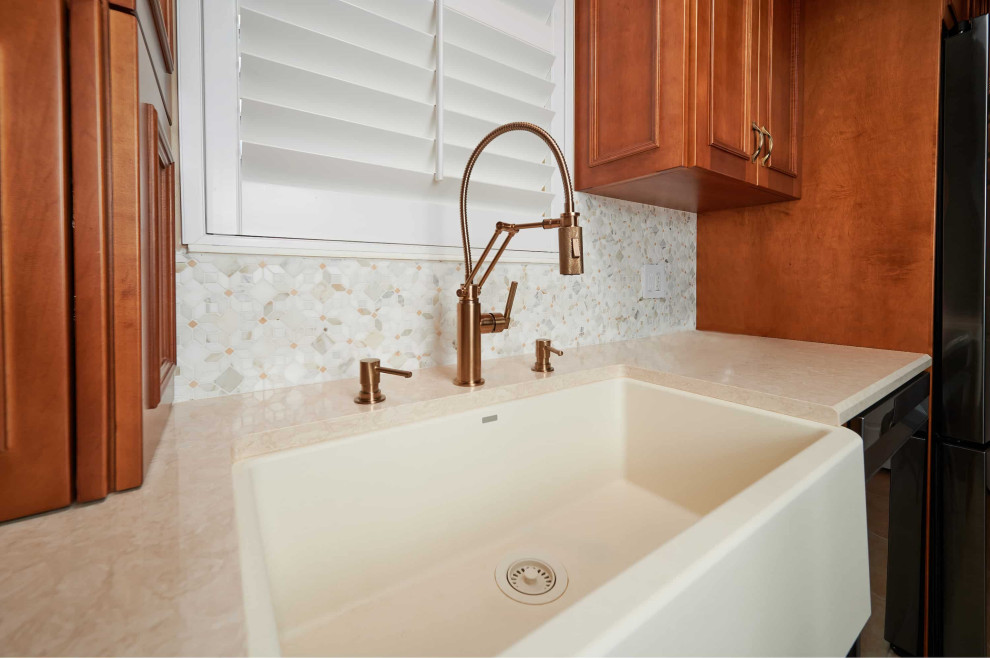 Example of a mid-sized transitional galley porcelain tile, beige floor and tray ceiling kitchen design with a farmhouse sink, recessed-panel cabinets, medium tone wood cabinets, quartz countertops, multicolored backsplash, marble backsplash, stainless steel appliances, a peninsula and beige countertops