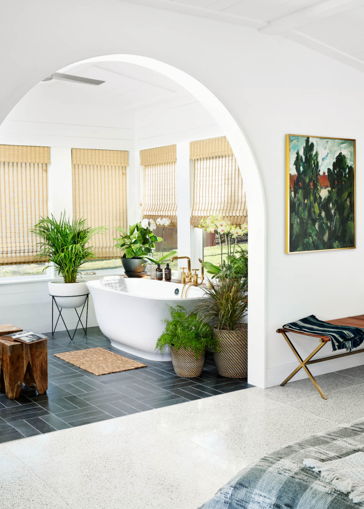 Inspiration for a large midcentury master bathroom in Austin with flat-panel cabinets, green cabinets, a freestanding tub, white tile, white walls, a drop-in sink, black floor, white benchtops, a double vanity, a built-in vanity and panelled walls.