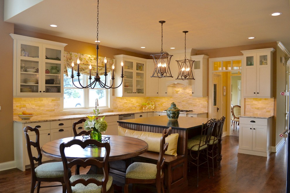 Mid-sized transitional u-shaped medium tone wood floor and brown floor eat-in kitchen photo in Chicago with an undermount sink, flat-panel cabinets, white cabinets, granite countertops, yellow backsplash, limestone backsplash, stainless steel appliances and an island