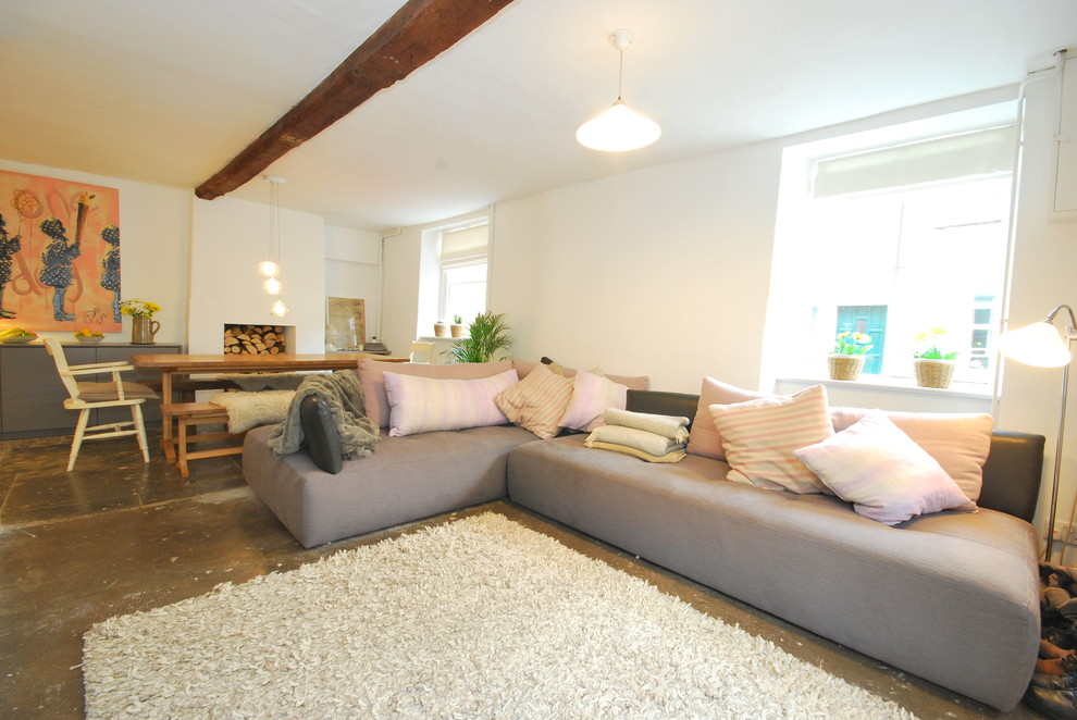 Inspiration for a small contemporary open plan living room in Other with white walls, concrete flooring, a wood burning stove, a stone fireplace surround and a freestanding tv.