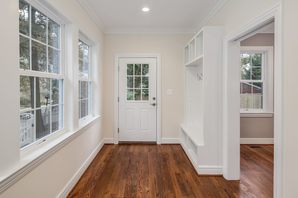 This is an example of a mid-sized transitional mudroom in DC Metro with beige walls, medium hardwood floors, a single front door and a white front door.