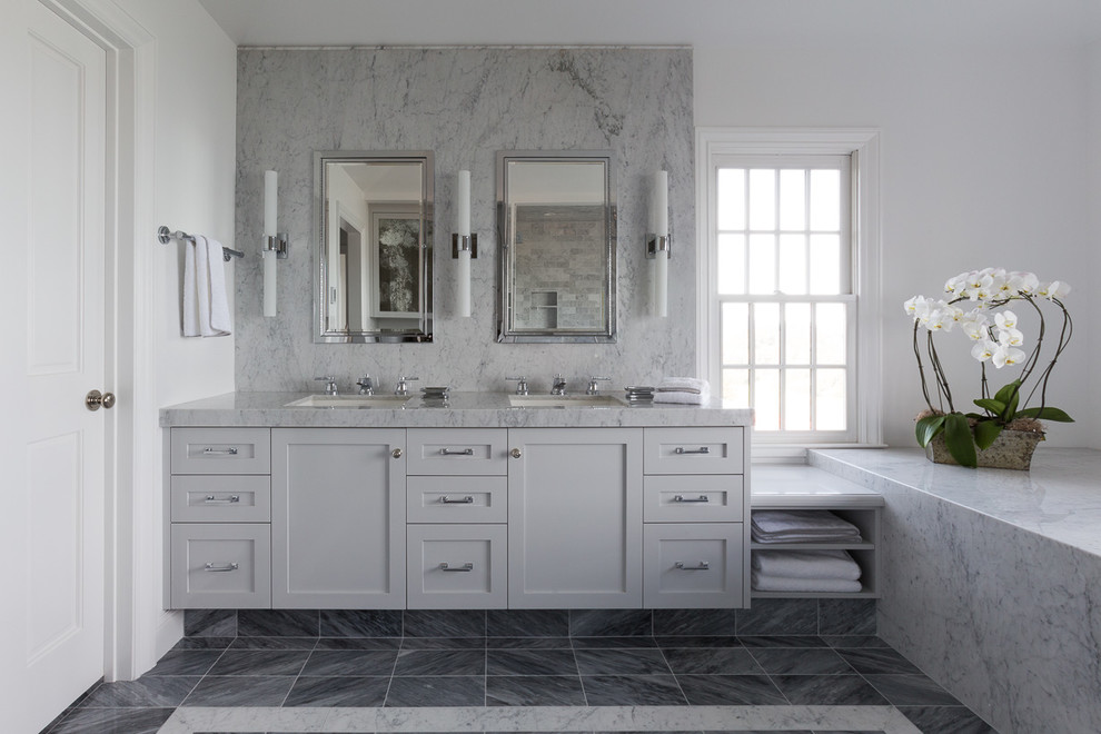 Design ideas for a mid-sized transitional master bathroom in San Francisco with shaker cabinets, grey cabinets, a two-piece toilet, gray tile, white tile, stone slab, white walls, porcelain floors, an undermount sink and marble benchtops.