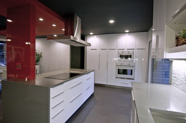 Design ideas for a mid-sized modern u-shaped eat-in kitchen in Charlotte with a double-bowl sink, flat-panel cabinets, white cabinets, quartz benchtops, white splashback, glass tile splashback, white appliances, linoleum floors and with island.