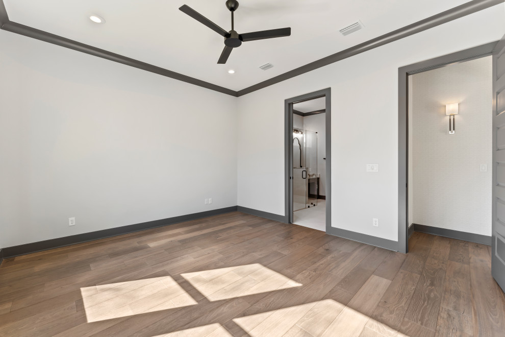 Inspiration for a mid-sized transitional master medium tone wood floor and brown floor bedroom remodel