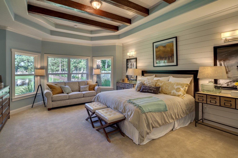 This is an example of a large transitional master bedroom in Jacksonville with blue walls, carpet and no fireplace.