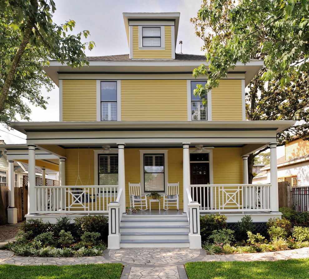 Inspiration for a traditional yellow exterior in Houston with wood siding.