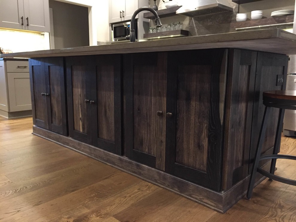 Large transitional l-shaped open concept kitchen photo in Grand Rapids with flat-panel cabinets and an island