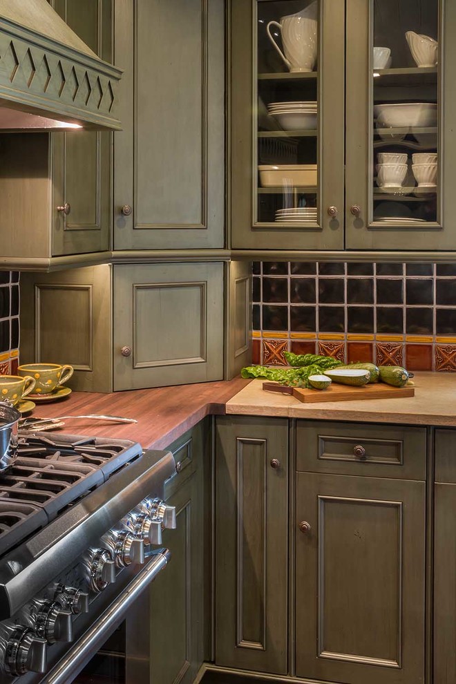Inspiration for a small country l-shaped eat-in kitchen in Chicago with a farmhouse sink, flat-panel cabinets, green cabinets, limestone benchtops, multi-coloured splashback, porcelain splashback, stainless steel appliances, medium hardwood floors, with island and brown floor.