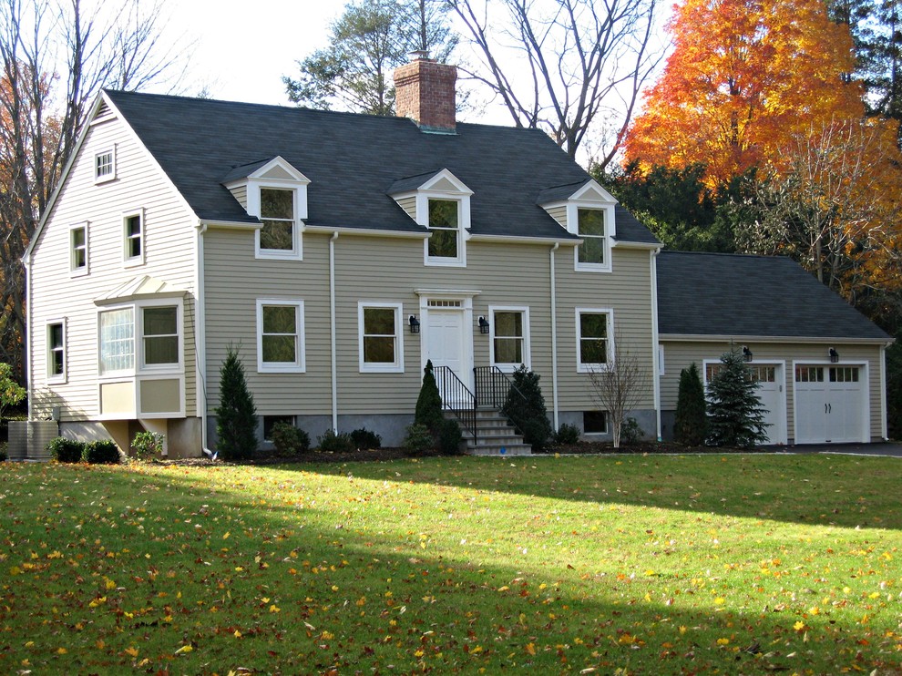 This is an example of a large traditional two-storey beige exterior in New York with vinyl siding.