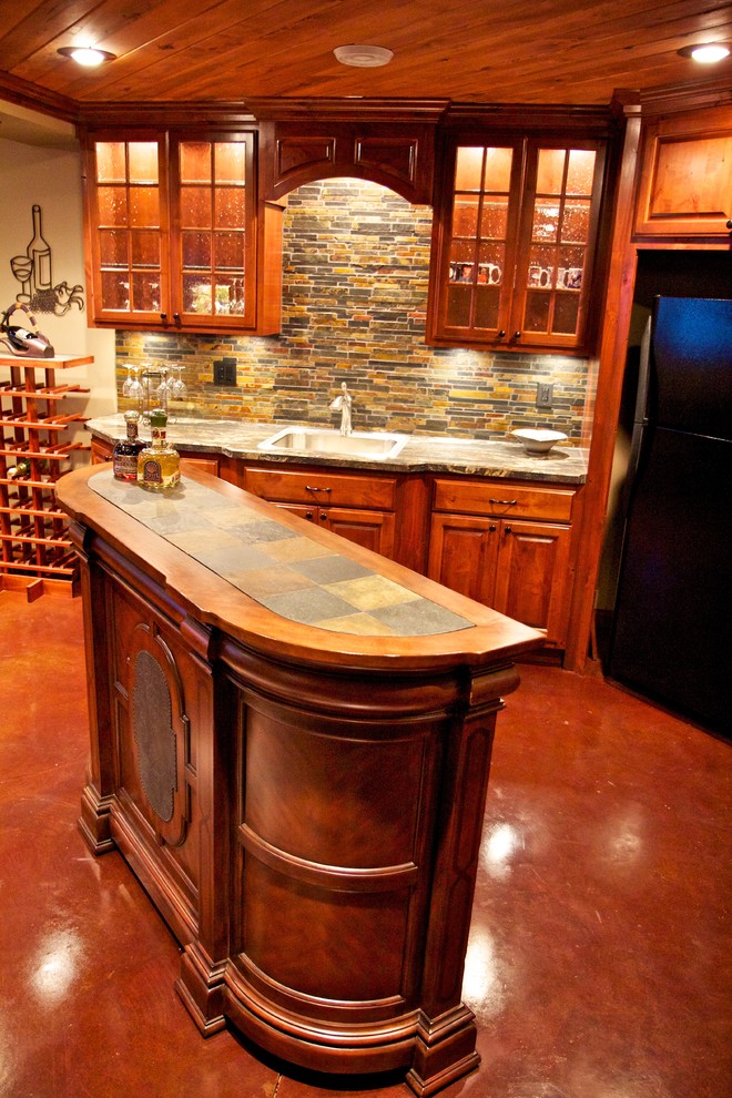 Example of a mid-sized l-shaped concrete floor open concept kitchen design with a drop-in sink, raised-panel cabinets, medium tone wood cabinets, laminate countertops, multicolored backsplash, stone tile backsplash and stainless steel appliances