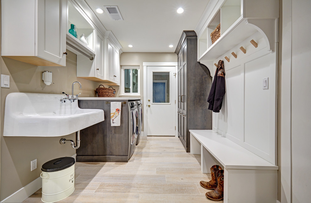 Mid-sized country galley utility room in Sacramento with an utility sink, recessed-panel cabinets, white cabinets, quartz benchtops, beige walls, porcelain floors, a side-by-side washer and dryer and beige floor.